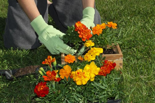Front view of a gardener preparing tools near payment device